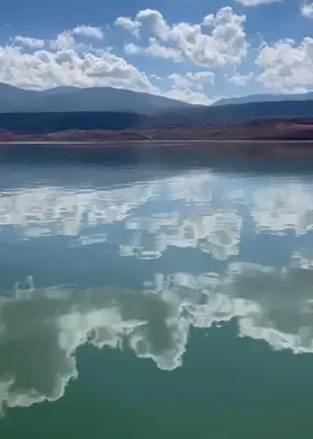 a large body of water with clouds in the sky at Atlas AGUELMAM in Bine el Ouidane