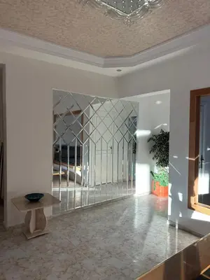 a room with a glass partition with a table in it at APPARTEMENTS NIA CONFORT, Plein centre ville, avec TERRASSE in Fès