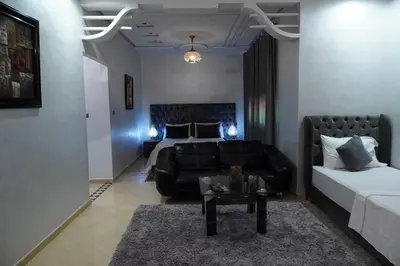 a living room with a couch and a bed at La Palmeraie De Moulay Yacoub in Moulay Yacoub