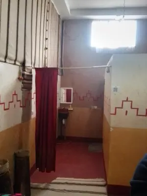a room with a red curtain and a red carpet at Hotel restaurant ait saderat in Boumalne