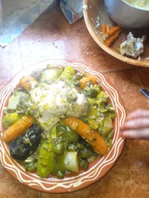 a plate of food with vegetables on a table at Hotel restaurant ait saderat in Boumalne