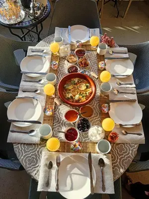 a table with plates and bowls of food on it at Hotel restaurant ait saderat in Boumalne