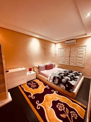 a bedroom with a bed and a large rug at Villa Ms Holidays Mika privatisée Marrakech in Marrakech