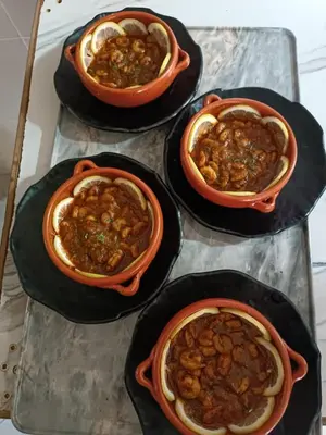 four bowls of food sitting on a table at Hotel Riad Taounate in Taounate