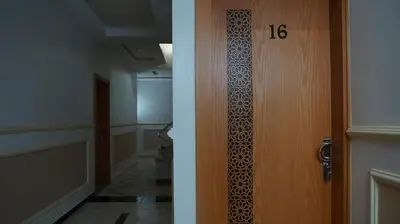 a door with a number on it next to a hallway at Hotel Riad Taounate in Taounate