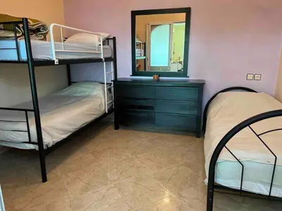 a bedroom with two bunk beds and a mirror at Appartement chaleureux Azrou in Azrou
