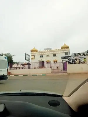 a car parked on a street with a white building at holiday apartment rental in Meknès