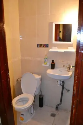 a bathroom with a toilet and a sink at holiday apartment rental in Meknès