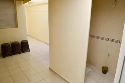 a hallway of a bathroom with a tile floor at holiday apartment rental in Meknès