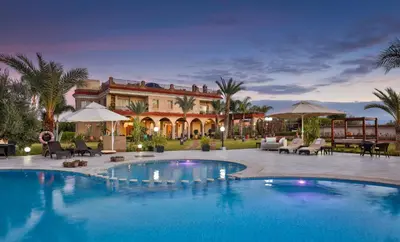 a large swimming pool in front of a house at Palais Amador in Marrakech