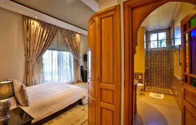 a bedroom with a bed and a large window at Palais Amador in Marrakech