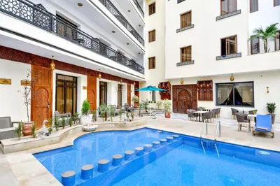 a hotel swimming pool in the middle of a building at Fes Heritage Boutique luxury Hotel in Fès