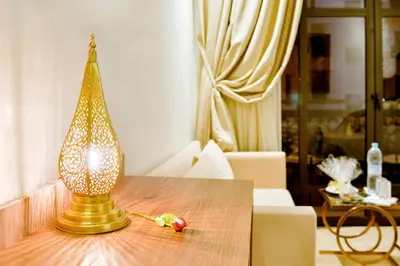 a lamp sitting on top of a wooden table at Fes Heritage Boutique luxury Hotel in Fès