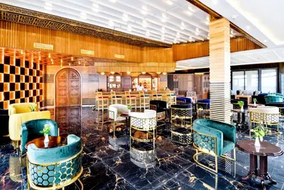 a restaurant with blue chairs and tables and a bar at Fes Heritage Boutique luxury Hotel in Fès