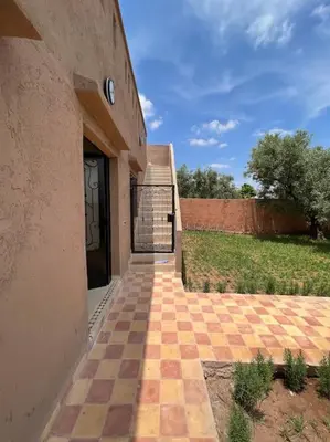 an entrance to a building with a clock on the door at Villa privative tortues2 piscine chauffée 35min Marrakech in Marrakech