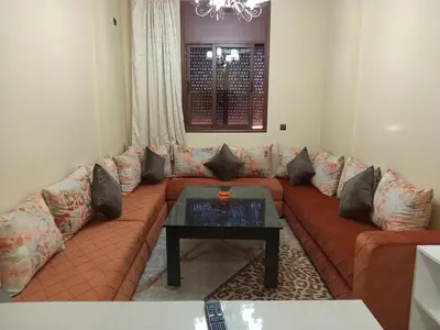 a living room with a couch and a coffee table at Résidence Jannat in Ouarzazate
