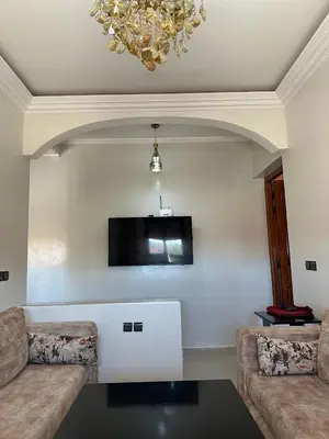 a living room with two couches and a tv at Résidence Jannat in Ouarzazate