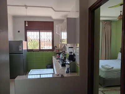 a kitchen with green walls and a counter top at Résidence Jannat in Ouarzazate