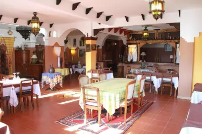 a dining room with a table and chairs at Kasba Oum Hani d'Ouzoud in Ouzoud