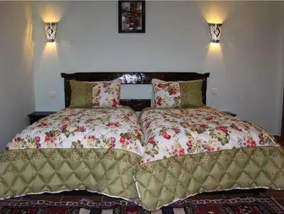 a bedroom with a large bed with two pillows at Kasba Oum Hani d'Ouzoud in Ouzoud