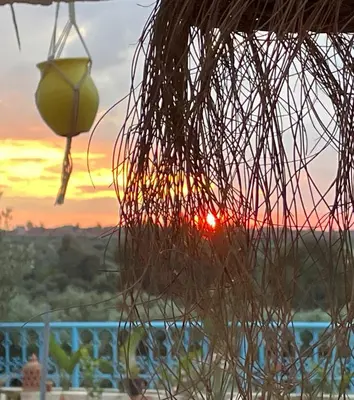 a view of the sunset from a resort at Villa Andaloussya, Majorel Host in Aït Ourir