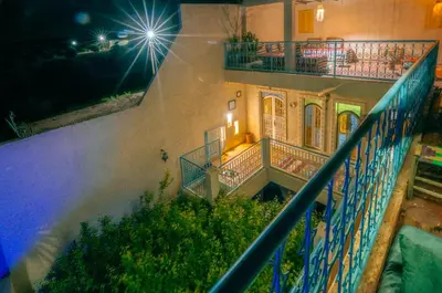 an external view of a building with a balcony at Villa Andaloussya, Majorel Host in Aït Ourir