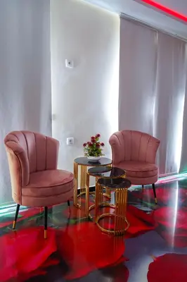two chairs and a table in a room at FEKRI HOTEL in Meknès