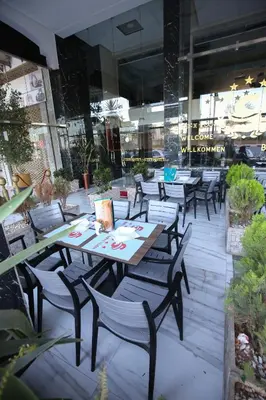 a table and chairs sitting outside of a restaurant at FEKRI HOTEL in Meknès