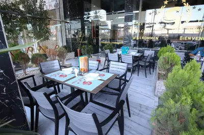 a table and chairs in front of a restaurant at FEKRI HOTEL in Meknès