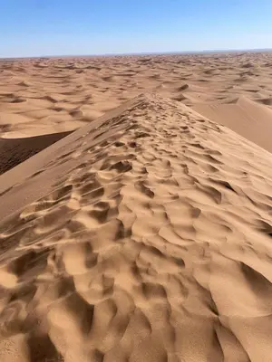 a sand dune in the middle of a desert at Desert Erg Chegaga Camp in El Gouera