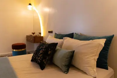 a pile of pillows sitting on top of a bed at Imlil apartment climatisé in Azrou