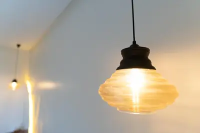 aendant light hanging from the ceiling in a room at Imlil apartment climatisé in Azrou
