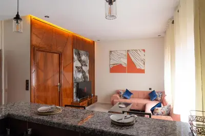 a living room with a couch and a table at Imlil apartment climatisé in Azrou