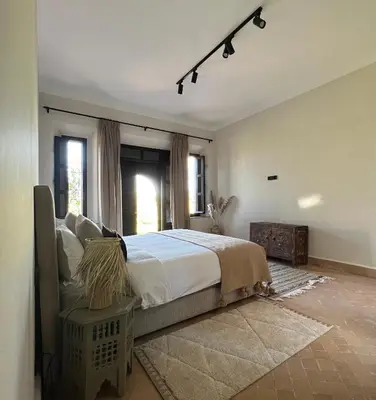a bedroom with a large bed and a window at Villa Beij in Marrakech