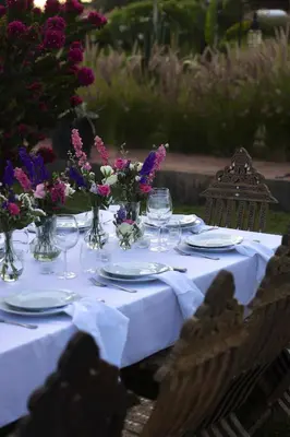 a table with plates and vases with flowers on it at Villa Beij in Marrakech