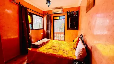 a bedroom with a bed and a window at Chez Ali Zagora Authentic Hotel Restaurant and Desert Excursions in Zagora