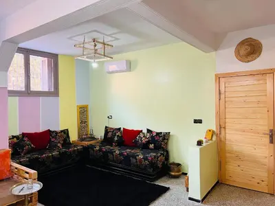 a living room with a couch and a window at spacious apartment with terrace in Fès