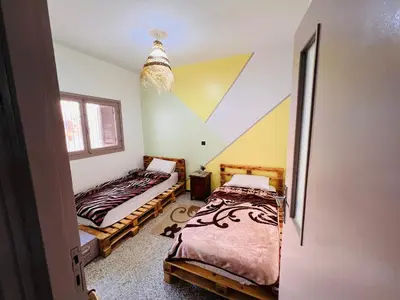 two beds in a room with a attic at spacious apartment with terrace in Fès