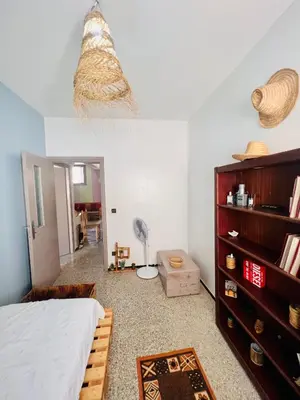 a bedroom with a bed and a book shelf at spacious apartment with terrace in Fès