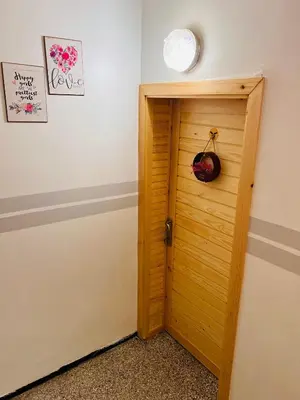 a wooden door in a room with a light at spacious apartment with terrace in Fès