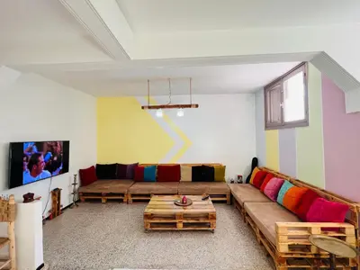 a living room with a couch and a table at spacious apartment with terrace in Fès
