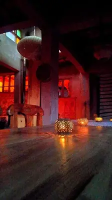 a room with a chair and lights on the floor at Auberge Ayouze in Aït Ben Haddou