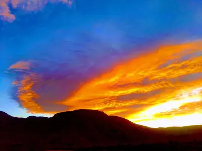 an image of a sunset with a mountain at Auberge Ayouze in Aït Ben Haddou