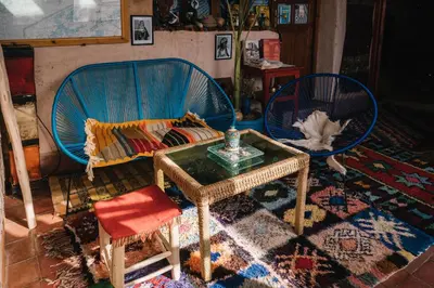 a living room with two chairs and a couch and a table at Auberge Ayouze in Aït Ben Haddou