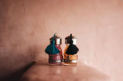two vases are sitting on a wall with their backsides toweredwered at Auberge Ayouze in Aït Ben Haddou