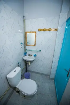 a bathroom with a toilet and a sink at Etoile des Gorges in Aït Baha
