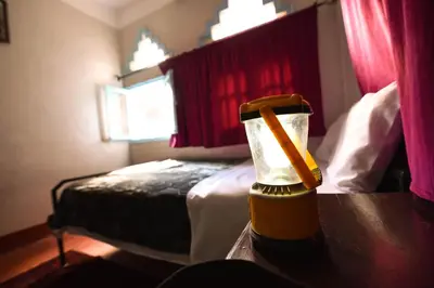 a hotel room with a bed with a bottle on a table at Etoile des Gorges in Aït Baha