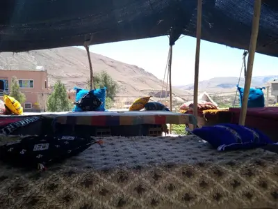 a bed under a tent in the desert at Auberge Amazigh in Tamtetoucht
