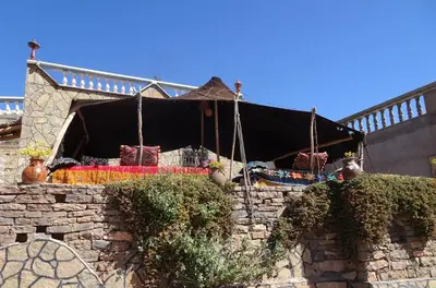a tent in a stone wall with plants at Auberge Amazigh in Tamtetoucht