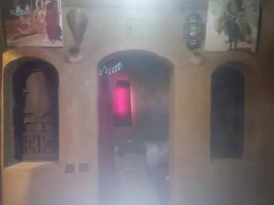 a hallway in a building with a red light at Auberge Amazigh in Tamtetoucht